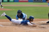 Tampa Bay Rays catcher Francisco Mejia, venter top, is late on a tag as Toronto Blue Jays' Bo Bichette, center bottom, scores at home plate during the first inning of a spring training baseball game Friday, March 3, 2023, in Dunedin, Fla. (Douglas R. Clifford/Tampa Bay Times via AP)