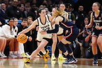 Apr 5, 2024; Cleveland, OH, USA; Iowa Hawkeyes guard Caitlin Clark (22) controls the ball against Connecticut Huskies guard Paige Bueckers (5) in the fourth quarter in the semifinals of the Final Four of the womens 2024 NCAA Tournament at Rocket Mortgage FieldHouse. Mandatory Credit: Kirby Lee-USA TODAY Sports