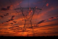The sun begins to rise near power lines Saturday, Sept. 16, 2023, near Monee, Ill. (AP Photo/Charles Rex Arbogast)