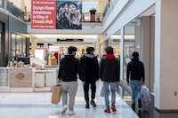 FILE PHOTO: People carrying shopping bags walk inside the King of Prussia shopping mall, as shoppers show up early for the Black Friday sales, in King of Prussia, Pennsylvania, U.S. November 26, 2021.  REUTERS/Rachel Wisniewski/File Photo