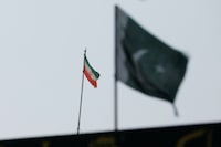 The flag of Iran is seen over its consulate building, with Pakistan's flag in the foreground, after the Pakistani foreign ministry said the country conducted strikes inside Iran targeting separatist militants, two days after Tehran said it attacked Israel-linked militant bases inside Pakistani territory, in Karachi, Pakistan January 18, 2024. REUTERS/Akhtar Soomro