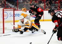 Pittsburgh Penguins defenceman Mark Friedman (52) dives in front of the net as Ottawa Senators left wing Tim Stützle (18) attempts a shot during second period NHL hockey action in Ottawa on Wednesday, Jan. 18, 2023. THE CANADIAN PRESS/Sean Kilpatrick
