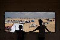 Palestinian children stand in a camp for displaced people in Rafah in the southern Gaza Strip by the border with Egypt on April 28, 2024, amid the ongoing conflict between Israel and the Palestinian militant group Hamas. (Photo by AFP) (Photo by -/AFP via Getty Images)