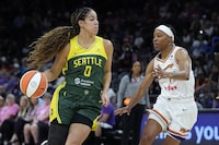 Seattle Storm guard Kia Nurse (0) dribbles the ball against Phoenix Mercury guard Shey Peddy during the first half of a WNBA basketball game Saturday, Aug. 5, 2023, in Phoenix. (AP Photo/Ross D. Franklin)