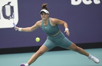 Bianca Andreescu, of Canada, returns a volley from Emma Raducanu, of Great Britain, in the first set of a match at the Miami Open tennis tournament, Wednesday, March 22, 2023, in Miami Gardens, Fla. (AP Photo/Jim Rassol)