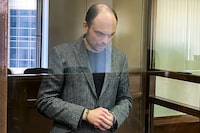 In this handout photo released by the Moscow City Court, Russian opposition activist Vladimir Kara-Murza stands in a glass cage in a courtroom at the Moscow City Court in Moscow, Monday April 17, 2023. A top Kremlin foe was convicted Monday on charges of treason and denigrating the Russian military and sentenced him to 25 years in prison after a trial that marked the latest move in a relentless crackdown on the opposition amid the fighting in Ukraine. (The Moscow City Court via AP)