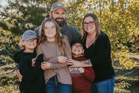 <p>Nine-year-old Carter Vigh, wearing a red sweatshirt, is pictured with his brother Daxton (left), sister Cadence, father James and mother Amber. Carter died of asthma exacerbated by wildfire smoke in July 2023. THE CANADIAN PRESS/HO-Amber Vigh &nbsp;&nbsp;*MANDATORY CREDIT *</p>