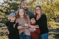 <p>Nine-year-old Carter Vigh, wearing a red sweatshirt, is pictured with his brother Daxton (left), sister Cadence, father James and mother Amber. Carter died of asthma exacerbated by wildfire smoke in July 2023. THE CANADIAN PRESS/HO-Amber Vigh &nbsp;&nbsp;*MANDATORY CREDIT *</p>