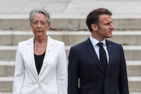 FILE - French President Emmanuel Macron and French Prime Minister Elisabeth Borne attend a WWII ceremony marking the 83rd anniversary of late French General Charles de Gaulle's resistance call of 18 June 1940, at the Mont Valerien memorial in Suresnes near Paris, Sunday June 18 2023. French President Emmanuel Macron on Monday Jan.8, 2024 accepted the resignation of Prime Minister Elisabeth Borne, the president's office said. Borne's resignation follows recent political tensions over a contentious immigration bill backed by Macron that would strengthen the government's ability to deport some foreigners, among other measures. (Mohammed Badra, Pool via AP, File)