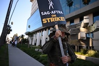 SAG-AFTRA members and their supporters picket outside Netflix during their strike against the Hollywood studios, in Hollywood, California, on November 8, 2023. The union representing striking actors said on November 6, 2023, it could not agree to studios' "last, best and final offer" issued over the weekend in a bid to end a months-long stalemate that has crippled Hollywood. (Photo by Robyn Beck / AFP) (Photo by ROBYN BECK/AFP via Getty Images)
