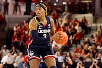 There are a few Canadian women with sights set on leaving their imprint at March Madness. The NCAA women's basketball tournament begins Wednesday with two First Four games, followed by 32 first-round games on Friday and Saturday. UConn's Aaliyah Edwards (3) looks to pass the ball against North Carolina State during the second half of an NCAA college basketball game, Sunday, Nov. 12, 2023, in Raleigh, N.C. THE CANADIAN PRESS/AP-Karl B. DeBlaker