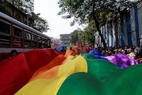 FILE PHOTO: Participants hold a rainbow flag during gay pride parade, which is promoting gay, lesbian, bisexual and transgender rights, in Mumbai, January 31, 2015. REUTERS/Danish Siddiqui/File Photo