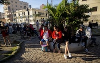 People wait in a park to be called on by the nearby U.S. embassy on the day of its reopening for visa and consular services in Havana, Cuba, Wednesday, Jan. 4, 2023. (AP Photo/Ismael Francisco)