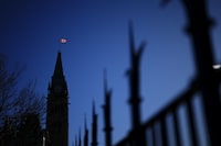 The Canada flag catches the morning light on the Peace Tower on Parliament Hill in Ottawa on Tuesday, April 16, 2024. THE CANADIAN PRESS/Sean Kilpatrick
