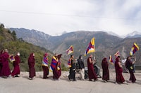Exile Tibetans carry flags and shout slogans as they participate in rally to commemorate the 1959 uprising in Tibet on this day, in Dharamshala, India, Sunday, March 10, 2024. (AP Photo/Ashwini Bhatia)
