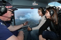 (L-R) Country Fire Authority (CFA) Chief Officer Jason Heffernan, Victorian Premier Jacinta Allan and Victorian Emergency Services Minister Jaclyn Symes on a helicopter tour over the bushfire north of Beaufort, near Ballarat in Victoria, February 24, 2024. Firefighters are continuing to battle a large bushfire in western Victoria with authorities concerned conditions in the coming week will be the worst in four years. AAP Image/David Crosling/Pool via REUTERS  ATTENTION EDITORS - THIS IMAGE WAS PROVIDED BY A THIRD PARTY. NO RESALES. NO ARCHIVE. NEW ZEALAND OUT. NO COMMERCIAL OR EDITORIAL SALES IN NEW ZEALAND. AUSTRALIA OUT. NO COMMERCIAL OR EDITORIAL SALES IN AUSTRALIA