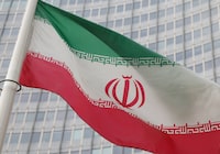 FILE PHOTO: The Iranian flag flutters outside the International Atomic Energy Agency (IAEA) headquarters in Vienna, Austria, March 6, 2023. REUTERS/Leonhard Foeger/File Photo