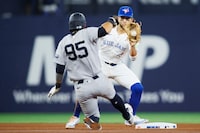 TORONTO, CANADA - APRIL 17: Bo Bichette #11 of the Toronto Blue Jays gets the force out on Oswaldo Cabrera #95 of the New York Yankees at second base in the seventh inning of their MLB game at Rogers Centre on April 17, 2024 in Toronto, Canada. (Photo by Cole Burston/Getty Images)