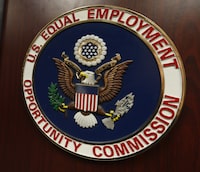 FILE - The emblem of the U.S. Equal Employment Opportunity Commission is shown on a podium in Vail, Colo., Tuesday, Feb. 16, 2016, in Denver. Pregnant workers have the right to a wide range of accommodations under new federal regulations for implementing the Pregnant Workers Fairness Act. The regulations take an expansive view of conditions related to pregnancy, from fertility treatments to abortion and post-childbirth complications. (AP Photo/David Zalubowski, File)
