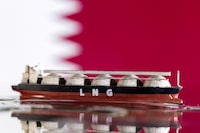 FILE PHOTO: Model of LNG tanker is seen in front of Qatar's flag in this illustration taken May 19, 2022. REUTERS/Dado Ruvic/Illustration//File Photo