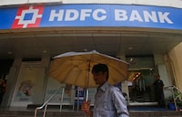 A customer walks outside an HDFC Bank branch in Mumbai July 17, 2013. REUTERS/Danish Siddiqui/Files