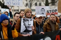 A man holds a photo of Alexei Navaln at a rally on February 18, 2024 in front of the Russian embassy in Berlin, following the death of the Kremlin's most prominent critic Alexei Navalny in an Arctic prison. Navalny's death after three years in detention and a poisoning which he blamed on the Kremlin deprives Russia's opposition of its figurehead at time of intense repression and Moscow's campaign in Ukraine. (Photo by Odd ANDERSEN / AFP) (Photo by ODD ANDERSEN/AFP via Getty Images)