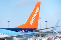 A Sunwing aircraft is parked at Montreal Trudeau airport in Montreal on Wednesday, March 2, 2022.&nbsp;WestJet is planning to wind down Sunwing Airlines, integrating the low-cost carrier into its mainline business within two years as part of a plan to streamline operations. THE CANADIAN PRESS/Paul Chiasson