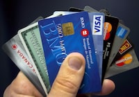 Credit cards are displayed in Montreal on December 12, 2012. Canadians may see a jump in businesses adding credit card surcharges as restrictions on the practice lift. THE CANADIAN PRESS/Ryan Remiorz