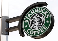FILE PHOTO: The Starbucks sign is seen outside one of its stores in New York July 3, 2008. REUTERS/Chip East (UNITED STATES)/File Photo/File Photo