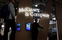 Visitors walk past the US global management consulting firm, McKinsey & Company, at the Mobile World Congress (MWC), the telecom industry's biggest annual gathering, in Barcelona on February 28, 2023. (Photo by Thomas COEX / AFP) (Photo by THOMAS COEX/AFP via Getty Images)
