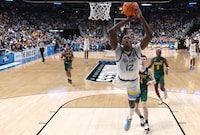 COLUMBUS, OHIO - MARCH 17: Olivier-Maxence Prosper #12 of the Marquette Golden Eagles fails to make a dunk against the Vermont Catamounts during the first half in the first round game of the NCAA Men's Basketball Tournament at Nationwide Arena on March 17, 2023 in Columbus, Ohio. (Photo by Dylan Buell/Getty Images)