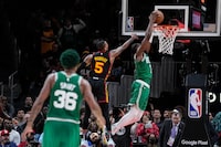 Boston Celtics guard Jaylen Brown (7) shoots and scores again Atlanta Hawks guard Dejounte Murray (5) during the second half of Game 4 of a first-round NBA basketball playoff series, Sunday, April 23, 2023, in Atlanta. (AP Photo/Brynn Anderson)