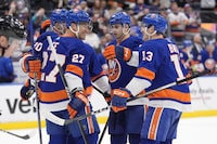 New York Islanders' Anders Lee (27) celebrates with teammates Hudson Fasching (20), Alexander Romanov and Mathew Barzal (13) after scoring a goal during the second period of an NHL hockey game against the Winnipeg Jets, Saturday, March 23, 2024, in Elmont, N.Y. (AP Photo/Frank Franklin II)