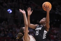 Gonzaga forward Yvonne Ejim (15) shoots over a Texas player during the first half of a Sweet 16 college basketball game in the women's NCAA Tournament, Friday, March 29, 2024, in Portland, Ore. (AP Photo/Howard Lao)