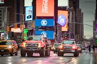 The AT44 and modified Ford F-150 drive through Times Square in New York City on the evening before the expedition's launch.