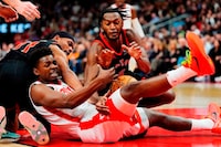 Houston Rockets forward Jae'Sean Tate (centre) battles for the ball with Toronto Raptors forward Bruce Brown (left) and guard Immanuel Quickley (right) during first half NBA basketball action in Toronto on Friday, February 9, 2024. THE CANADIAN PRESS/Frank Gunn