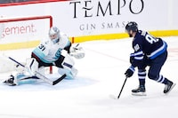 Feb 14, 2023; Winnipeg, Manitoba, CAN; Winnipeg Jets left wing Pierre-Luc Dubois (80) scores on Seattle Kraken goaltender Philipp Grubauer (31) in the shoot out at Canada Life Centre. Mandatory Credit: James Carey Lauder-USA TODAY Sports