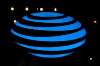 FILE PHOTO: The AT&T logo is seen in a store window in the Manhattan borough of New York City, New York, U.S., January 19, 2022.  REUTERS/Brendan McDermid/File Photo