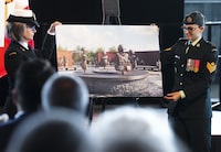 Petty Officer First Class Charlotte McShane, left, and Sergeant Missy Deschenes unveil the winning design for the national monument to Canada's mission in Afghanistan in Ottawa on Monday, June 19, 2023. THE CANADIAN PRESS/Sean Kilpatrick