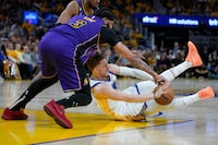 Los Angeles Lakers forward Anthony Davis (3) and Golden State Warriors guard Donte DiVincenzo compete for possession of the ball during the second half of Game 2 of an NBA basketball Western Conference semifinal game in San Francisco, Thursday, May 4, 2023. (AP Photo/Godofredo A. Vásquez)