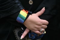 An LGTBQ activist wearing a rainbow flag wristband gathers with others at the courtyard of India's Supreme Court in New Delhi on October 17, 2023. India's top court ruled on October 17 it did not have the power to legalise same-sex marriages and said any reform to that effect would have to come from parliament. (Photo by Sajjad HUSSAIN / Sajjad HUSSAIN / AFP) (Photo by SAJJAD HUSSAIN/Sajjad HUSSAIN/AFP via Getty Images)