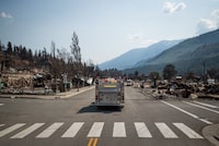 British Columbia's auditor general says his office is doing a review of the province's response to the 2021 wildfire that devastated the community of Lytton, B.C. A fire truck leads a bus down Main Street past damaged structures during a media tour in Lytton, B.C., on Friday, July 9, 2021, after a wildfire destroyed most of the village on June 30. THE CANADIAN PRESS/Darryl Dyck