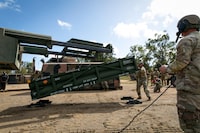 In this image provided by the U.S. Army U.S. Army Staff Sgt. Jimmy Lerma, crew chief for Alpha Battery, 1st Battalion, 3rd Field Artillery Regiment, 17th Field Artillery Brigade, adjusts the Army Tactical Missile System (ATACMS) for loading on to the High Mobility Artillery Rocket System (HIMARS) at Williamson Airfield in Queensland, Australia, on July 26, 2023. U.S. officials say Ukraine for the first time has begun using long-range ballistic missiles, called ATACMS, striking a Russian military airfield in Crimea and Russian troops in another occupied area overnight.  (Sgt. 1st Class Andrew Dickson/U.S. Army via AP)