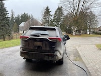 David Pease's Toyota RAV4 Prime plug-in hybrid is parked in his driveway. Because of a recall from Toyota, he is unable to charge it in cold weather.