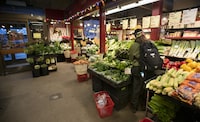 People shopping at a produce stand at the St. Lawrence Market in downtown Toronto, are photographed on Jan 17, 2023. Fred Lum/The Globe and Mail. 