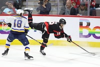 Ottawa Senators' Tim Stutzle (18) reaches for the puck in front of St. Louis Blues' Robert Thomas (18) during third period NHL hockey action in Ottawa on Thursday, March 21, 2024. THE CANADIAN PRESS/ Patrick Doyle