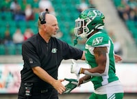 Saskatchewan Roughriders head coach Craig Dickenson greets Saskatchewan Roughriders defensive back Devin Jones (6) on the sidelines against the BC Lions during the second half of pre-season CFL football action in Regina, on Saturday, May 27, 2023. THE CANADIAN PRESS/Heywood Yu
