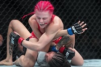 Gillian (The Savage) Robertson, top, fights Polyana Viana during the Women's Strawweight bout at UFC 297 in Toronto on Saturday, January 20, 2024. Canadians  Robertson and Marc-Andre (Powerbar) Barriault have been added to Conor McGregor's comeback fight card.THE CANADIAN PRESS/Nathan Denette