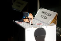 A person casts a ballot at a polling station during the presidential and parliamentary elections in Taipei, Taiwan January 13, 2024. REUTERS/Carlos Garcia Rawlins