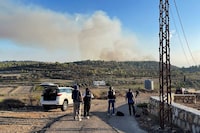 FILE PHOTO: Visual journalists film cross-border shelling at a site near the village of Alma al-Chaab in Lebanon, close to the Israeli border, October 13, 2023.  REUTERS/Issam Abdallah/File Photo